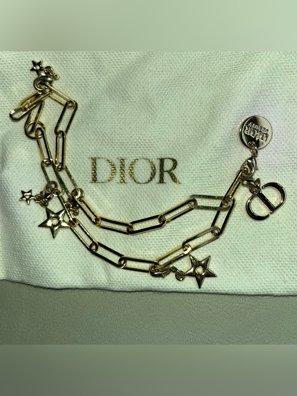 Dior Gold Star Link Phone Charm with Dior jewelry pouch